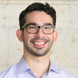 Headshot of Matt Giani - smiling man, thirties, black rimmed glasses