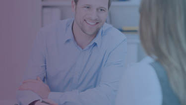Male counselor smiling at student